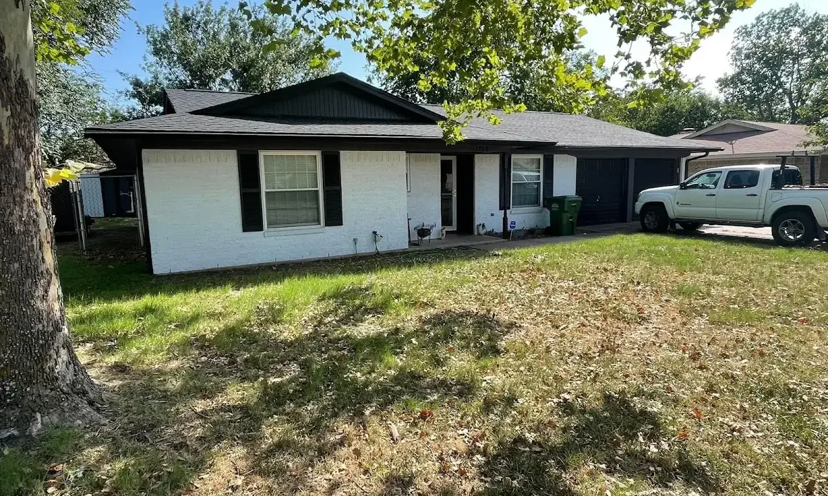 Professional roofing crew working on a residential roof in Harvard